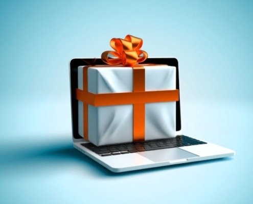 Ein Computermonitor mit einem Geschenkpaket als Symbol für das Verschenken von Wissen im Content-Marketing