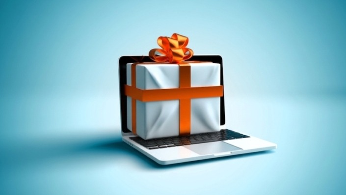 Ein Computermonitor mit einem Geschenkpaket als Symbol für das Verschenken von Wissen im Content-Marketing